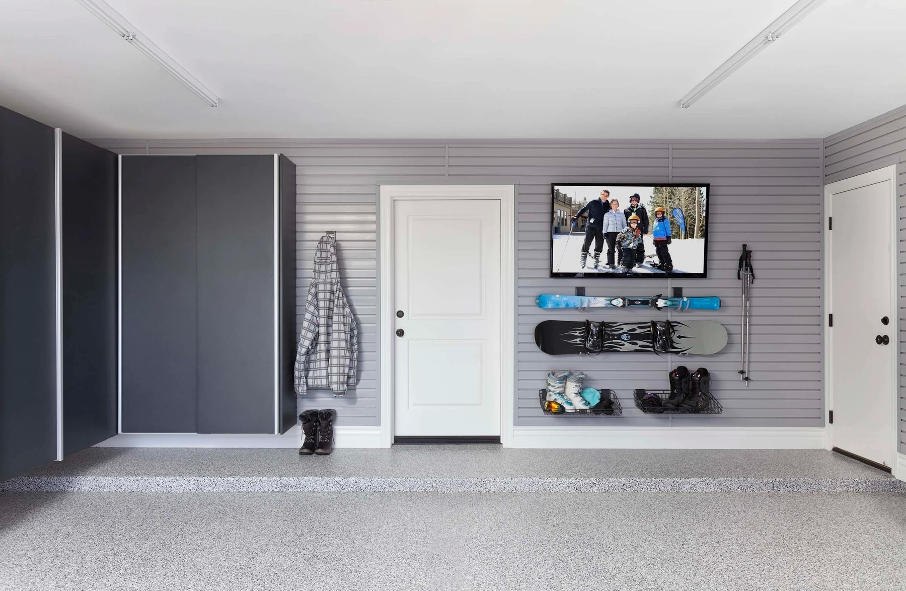 Low-Maintenance Epoxy Garage Floors: The Perfect Solution for Non-slip Floors & Easy Clean-up in the Wintertime Garage with TV, skiing gear and epoxy floors