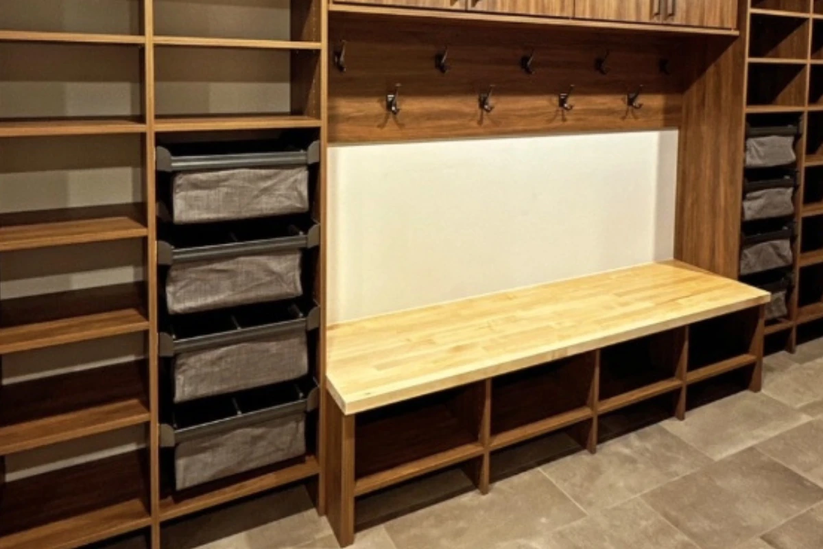 Mudroom featuring butcher block bench and fabric drawer baskets